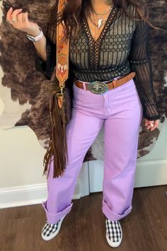 Our Raven Vintage Jeans are a straight VIBE!! High waisted light lavender color non stretch wide leg Rock these jeans to stand out from the crowd. Sporting a straight VIBE with a high waist and wide leg, they're perfect for adding a pop of lavender to any look. Waist size: (Small) 27.6 inch; (Medium) 29.1 inch; (Large) 31.5 inch Wide Leg Cowgirl Jeans, Purple Bell Bottoms Outfit, Space Cowgirl Pants, Purple Western Outfit, Western Wide Jeans, Weekend In Nashville, Ashley White, Purple Jeans, Fringe Crossbody Bag