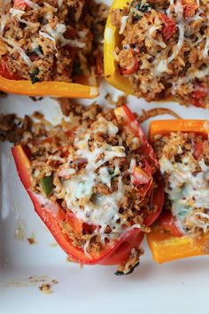 stuffed bell peppers with meat and cheese on a white plate