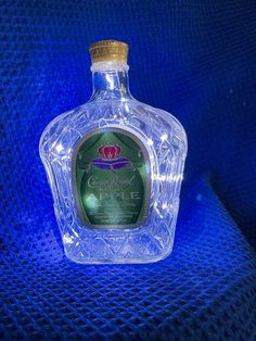 a glass bottle sitting on top of a blue cloth