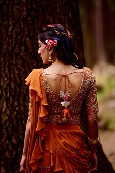 Editor's Note The Rust Orange 4- Layered Pre-draped Sari Comes With Dainty Gota Patti Borders Along With Naksha Embroidered Blouse Embellished With Dabka Work, Mirror, Moti, Cutdana And Zari Work Paired With Geometric Belt ; Works Well From Day Wear To Evening Look Color: Rust orange Fabric: Crepe Care: Dry Clean Only About the Designer Paulmi & Harsh is a luxury prêt label inspired by beautiful botanicals. Paulmi & Harsh design strong, feminine silhouettes with prints and delicate detailing, fu Festive Bollywood Hand Embellished Blouse, Bollywood Designer Hand Embellished Blouse, Traditional Hand Embellished Blouse For Reception, Traditional Wedding Blouse Hand Embellished, Traditional Hand Embellished Georgette Blouse, Hand Embellished Wedding Blouse With Traditional Drape, Hand Embellished Blouse For Wedding, Hand Embellished Tops For Wedding, Hand Embellished Blouse For Designer Wear With Traditional Drape