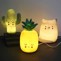 three different types of lights that look like pineapples and cactuses with faces on them