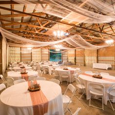 a banquet hall with white tables and chairs