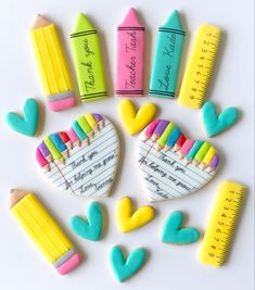 decorated cookies in the shape of pencils, crayons and heart shaped erasers