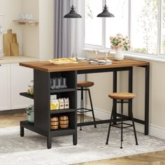 a kitchen island with two stools in front of it and an open shelf on the other side