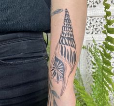 a woman with a tattoo on her arm