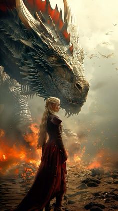 a woman standing in front of a dragon on top of a rocky hill next to a fire