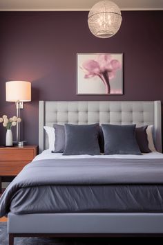 a bedroom with purple walls and white bedding