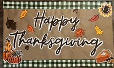 a happy thanksgiving sign with fall leaves and sunflowers on brown paper, which says happy thanksgiving