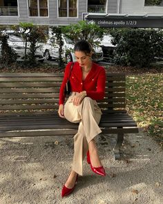 This look is perfect for those who want to stand out in the fall season while maintaining a touch of classic elegance. The bright red cardigan paired with beige trousers creates a striking yet balanced outfit. The gold buttons on the cardigan add a touch of luxury, making it suitable for various occasions, from casual outings to more formal events.   Photo credit by: @maevabuono Red Heels Outfit, Red Top Outfit, Red Shoes Outfit, Downtown Outfits, Nashville Outfits, Beige Outfit, Looks Chic, Red Outfit, Formal Outfit