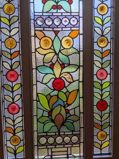 two stained glass windows with flowers and leaves on the bottom, one has a yellow light bulb