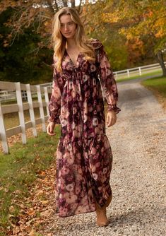 [Color: Plum/Dusty Rose] A full body front facing lifestyle image of a blonde model wearing a sheer Western Cocktail, Boho Holiday Dress, Bohemian Holiday, Romantic Florals, Holiday Maxi Dress, Purple Floral Print, Chiffon Maxi, Chiffon Maxi Dress, Wrist Cuffs