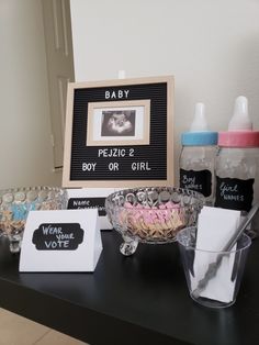 there is a baby announcement on the table with its name and pictures in front of it