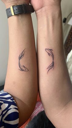 two women with matching tattoos on their arms