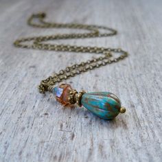 This listing is for this beautiful rustic pendant style necklace. The melon beads are 13x8mm, teal turquoise opaque glass with a Picasso Finish. The top bead is a clear, 6x8mm, glass turbine beads with a travertine Picasso finish on each end. This necklace is available with copper accents or antique brass. Both look lovely. Want another metal? Please contact me. To find more in this series (more to come), start here, https://www.etsy.com/shop/CraftLikeAnArtist?ref=seller-platform-mcnav&searc Turquoise Czech Glass Beaded Necklace For Gift, Turquoise Beaded Czech Glass Necklace, Bohemian Czech Glass Pendant Beaded Necklace, Bohemian Czech Glass Gemstone Necklaces, Bohemian Czech Glass Beaded Necklace Hand-strung, Necklace Bead, Copper Accents, Jewelry Simple, Teal Turquoise