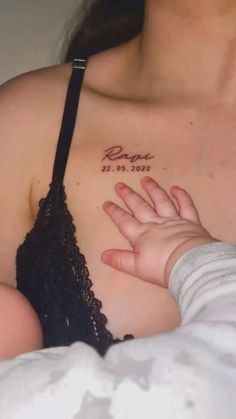 a woman holding her baby in her arms with the word peace written on it's chest