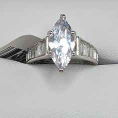 an engagement ring with a pear shaped diamond