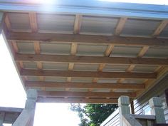 an outdoor covered porch with stairs and railings