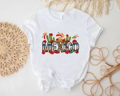 Mexico Shirt For Women, Mexico Trip Shirt, Latina Shirt, Cinco De Mayo Shirt, Hispanic Shirt,Mexican Festival Shirt,Travel Mexica Gift Shirt ----- How To Order ----- 1-) Please, check and review all the photos. 2-) Choose your t-shirt size and color. *Different styles of shirts may have different shades of same color choice due to different manufacturer brands. *For this reason, we recommend you to match shirts from the same styles if you want precisely matching colors (ex. Unisex, V-necks, Todd Multicolor Crew Neck Shirt For Cinco De Mayo, White Crew Neck Shirt For Cinco De Mayo, Casual Multicolor T-shirt For Fiesta, Casual Crew Neck T-shirt For Fiesta, Mexican Festival, Mexico Shirt, Mexican Shirt, Mexico Shirts, Mexico Trip