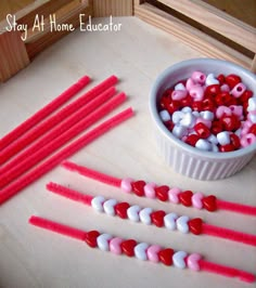 red, white and pink candy sticks in a bowl