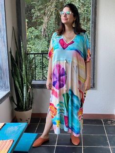 "This is our \"Timeless\" style kaftan. It features a drawstring that you can cinch at the waist. This loose fitting Caftan House dress is exceptionally comfortable and stylish. I created a short video about this style https://youtu.be/GDo-9c5XItk As for the fabric pattern, we have used a hand drawn and digitally painted technique. So they are all unique designs. It is like wearing wearable art. What I love about digital paintings is that they look as beautiful as the hand paintings but the care Casual V-neck Kaftan For Daywear, Multicolor Relaxed Fit V-neck Dress, Printed Multicolor Dresses For Loungewear, Multicolor Printed Dresses For Loungewear, Casual Multicolor V-neck Tunic, Multicolor Drawstring Dress For Vacation, Casual V-neck Relaxed Fit Kaftan, Multicolor V-neck Kaftan For Loungewear, Multicolor Rayon Kaftan For Spring