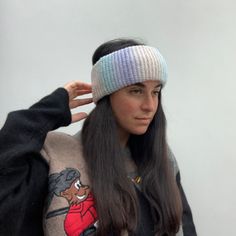 a woman with long hair wearing a knitted headband