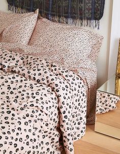 a leopard print comforter set on a bed