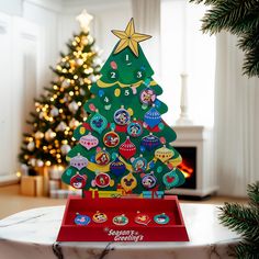 a wooden christmas tree on a table in front of a decorated christmas tree with lights