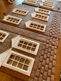 there are many windows on the table made out of gingerbreads and icing