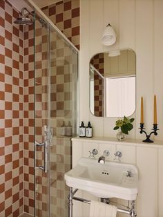 a white sink sitting under a bathroom mirror next to a walk in bathtub and shower