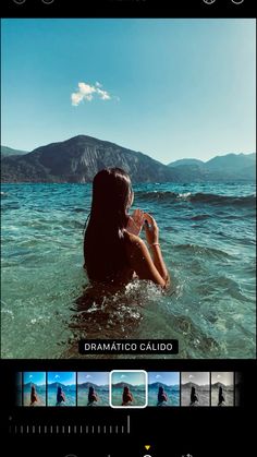 a woman is sitting in the water with her hands on her face and looking into the distance