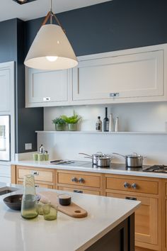 a kitchen with white cabinets and an island