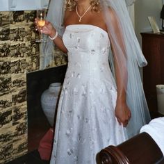 a woman in a wedding dress holding a wine glass