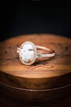 a close up of a ring on top of a wooden box