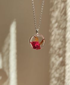 The real rose necklace was made with handpicked and pressed rose and epoxy resin. The dried flower is encased in silver color oval frame with clear resin. The resin protects the flower and at the same time it magnifies their beauty.  The sizes of the pendant is 2 cm x 2 cm. The chain length is 44 cm with 4 cm extension part and it's closed with a lobster clasp. (Totally 48 cm.) This dainty rose jewelry can be: - A perfect flower gift for rose lovers, - a unique birthday gift, an anniversary gift Rose Jewelry Flower, Real Rose, Jewelry Flower, Rose Pendant, Flower Gifts, Necklace Red, Rose Jewelry, Rose Necklace, Christmas Gift For Her