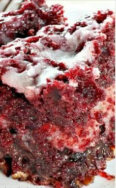 a close up of a piece of cake on a plate with icing and crumbs