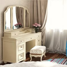 a bedroom with a vanity, mirror and stool in it's corner next to a window