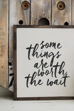 some things are worth the wait sign next to a vase and potted plant in front of a wooden wall