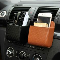 a cell phone and wallet holder in the dash of a car, with other items inside