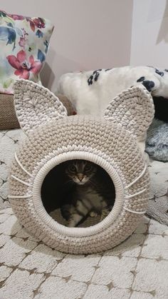 a cat laying in a bed made to look like an animal