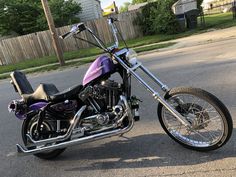 a purple and black motorcycle parked on the street