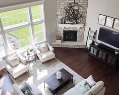 an aerial view of a living room with white furniture