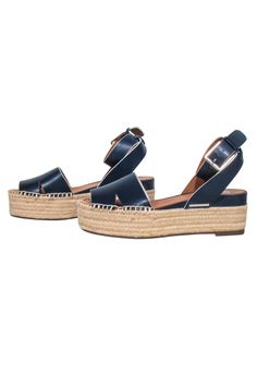 Make a splash in these navy blue leather Franco Sarto espadrilles! With a nautical feel cardted with nay leather and beige woven espadrille platform, they'll look fab-u-lous paired with a timeless white linen dress or pants for a timeless summer look. Size 8 Leather upper and interior Man made sole Adjustable ankle strap buckle closure Toe to heel 10" Heel height 2.5" Navy Round Toe Sandals With Cushioned Footbed, Blue Open Toe Espadrilles With Woven Sole, Blue Open-toe Espadrilles With Woven Sole, Blue Leather Espadrilles With Woven Sole, Blue Leather Beach Espadrilles, Blue Leather Espadrilles For Beach, Blue Leather Espadrilles For The Beach, Casual Leather Wedge Heel Espadrilles, Navy Sandals For Beach And Spring Season