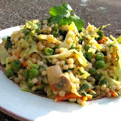 a white plate topped with rice and veggies