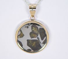 IMILAC PALLASITE METEORITE PENDANT - METEORITE JEWELRY - GOLD On Offer: Beautiful Imilac Pallasite Meteorite Pendant set in 14K Gold. Dimensions not including bail: Approximately 22.75mm x 3.40mm Dimensions including bail: Approximately 33.23mm x 6.34mm Includes an 18" gold chain. Value $450 The majestic Imilac meteorite is arguably one of the most beautiful pallasites ever discovered. The olivine crystals in these pallasite meteorites are among the most prized gemstones in the world. This piece Fine Jewelry In Yellow Gold With Natural Inclusions, Yellow Gold Jewelry With Natural Inclusions For Anniversary, Anniversary Pendant Jewelry With Natural Inclusions, Meteorite Jewelry, Meteorite Pendant, Gold Top, Pendant Set, Gold Chain, Gold Chains