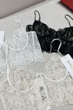 This bralette offers a stylish and supportive fit. Crafted with ultra-soft, stretchy fabric and a delicate lace trim, this bralette ensures maximum comfort. It features a front clasp closure and adjustable straps for a snug and secure fit that lasts all day. Lace Underbust Bra With Lace Closure, Underbust Bra With Lace Closure, Lace Camisole Bra With Removable Pads, Lace Camisole Bra With Lace Trim, Feminine Camisole Bra With Delicate Straps, Feminine Camisole Style Bra With Delicate Straps, Lace Camisole With Removable Bra Pads, Lace Cami Bra With Delicate Straps, Lace Camisole Bra With Delicate Straps