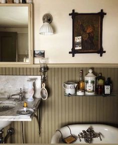 a bathroom with a sink, mirror and bathtub in the corner next to it