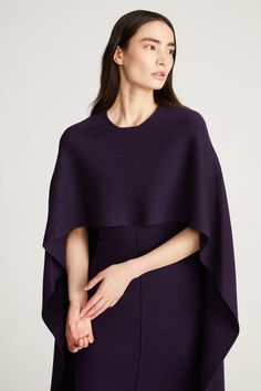 PRODUCT DETAILS Discover the effortlessly elegant Amal Dress. Designed with an elongated cape overlay across the back—striking the perfect balance of structure and flow. It’s crafted with extrafine merino wool, giving its canvas an extremely soft texture and lightweight feel—while maintaining its beautiful shape. Sheat Cape Sleeves, Summer Prints, Knitwear Tops, Color Stories, Midi Length Dress, Soft Texture, Dress Backs, Midi Length, Jumpsuit Dress