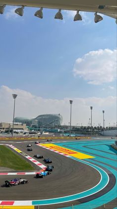 a race track with cars driving on it and the sky in the backgroud