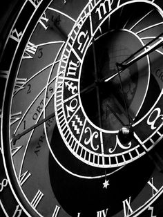 a large clock with roman numerals on it's face in black and white