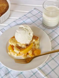 a white plate topped with food next to a glass of milk and a cup filled with ice cream